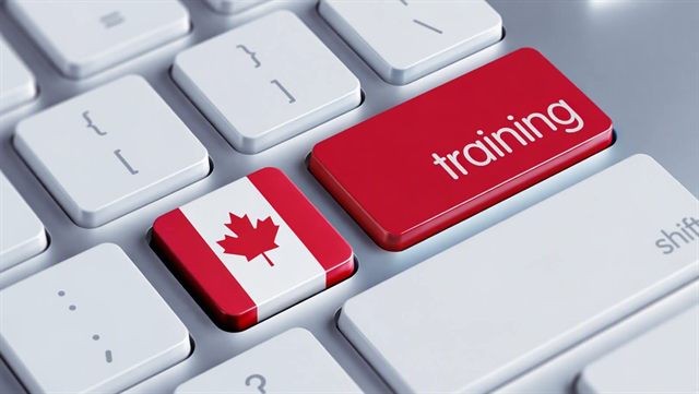 A computer keyboard with a Canadian flag key beside a red training key