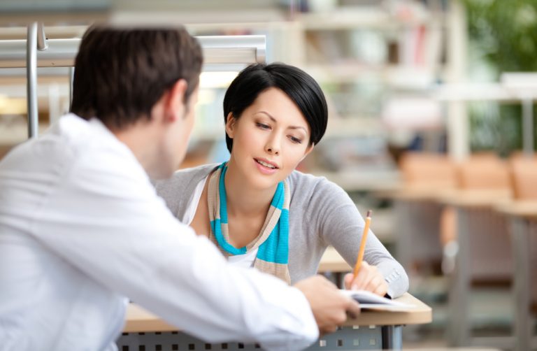 Two adults studying a language together